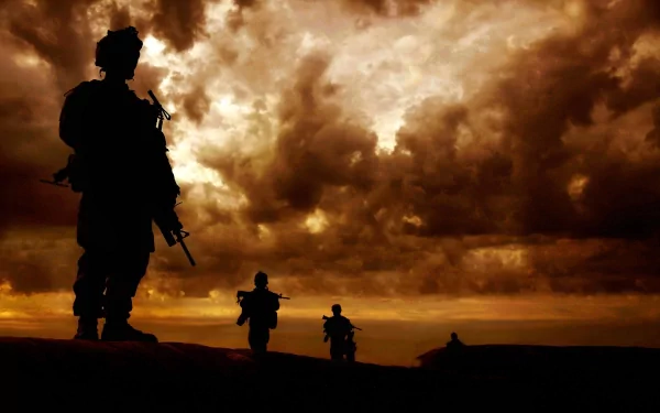 Silhouettes of soldiers against a dramatic sunset sky, capturing the essence of military service. This HD wallpaper serves as an evocative backdrop for a desktop.