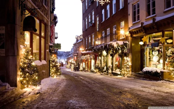 HD desktop wallpaper featuring a picturesque street adorned with Christmas lights, festive trees, and holiday decorations, creating a warm and inviting holiday scene.