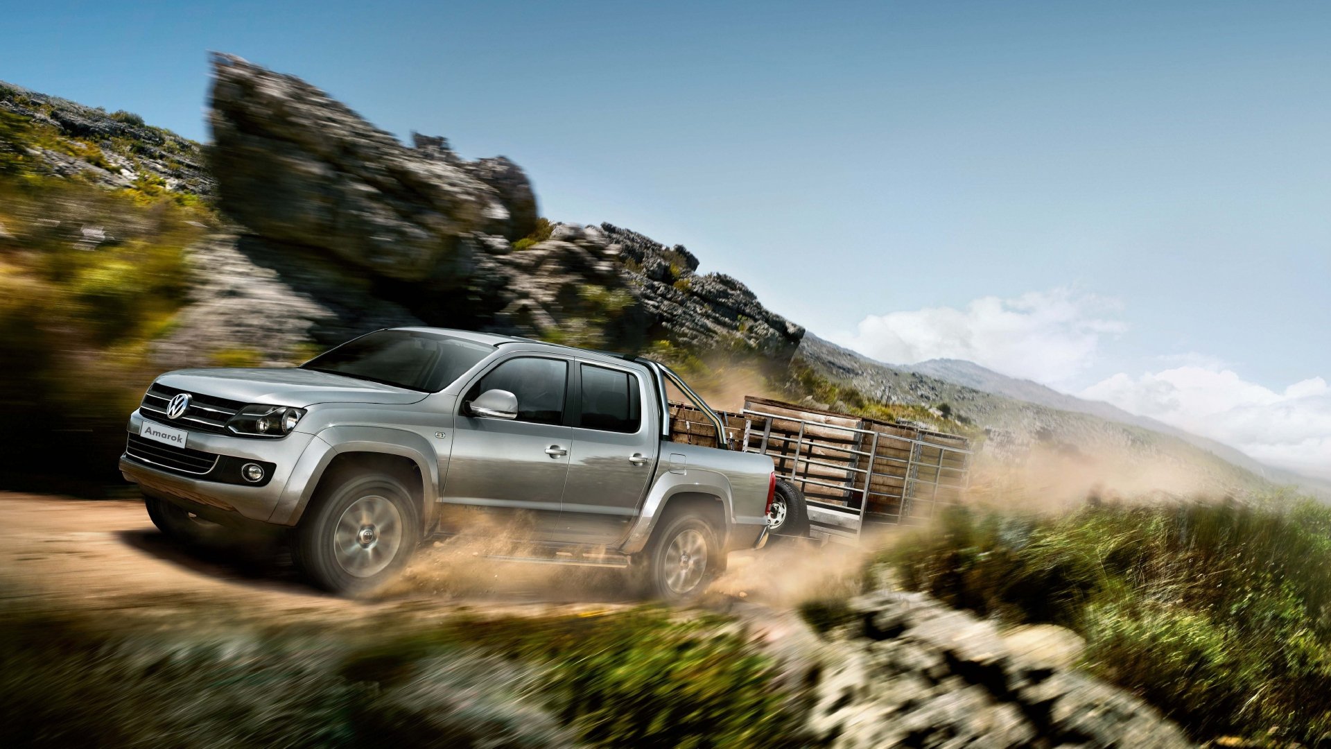 A Volkswagen pickup truck driving fast through a rugged mountainous landscape, kicking up dust, shown in 4K Ultra HD desktop wallpaper quality.