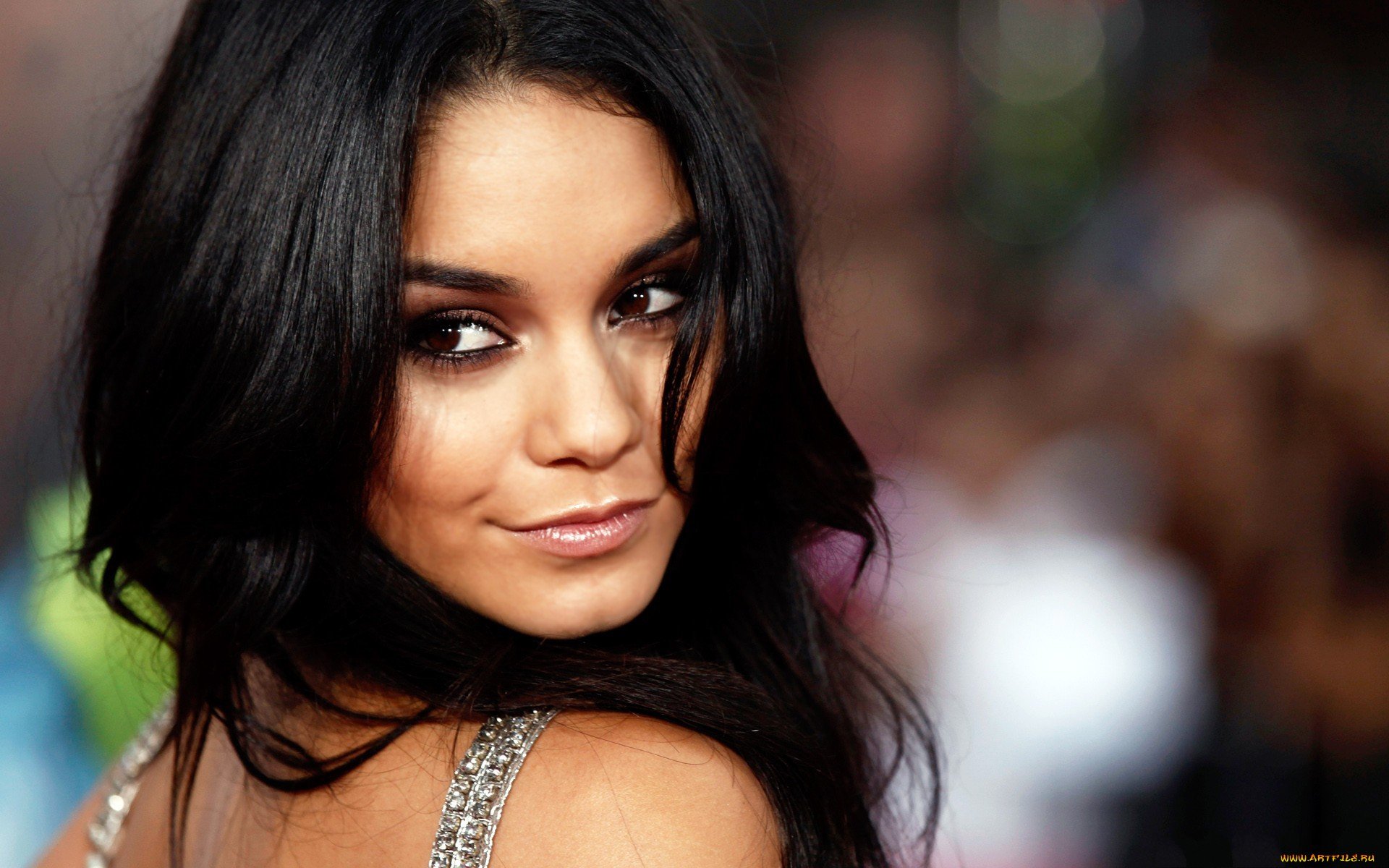 HD PC desktop wallpaper featuring a close-up of celebrity Vanessa Hudgens with dark hair and a subtle smile against a softly blurred background.