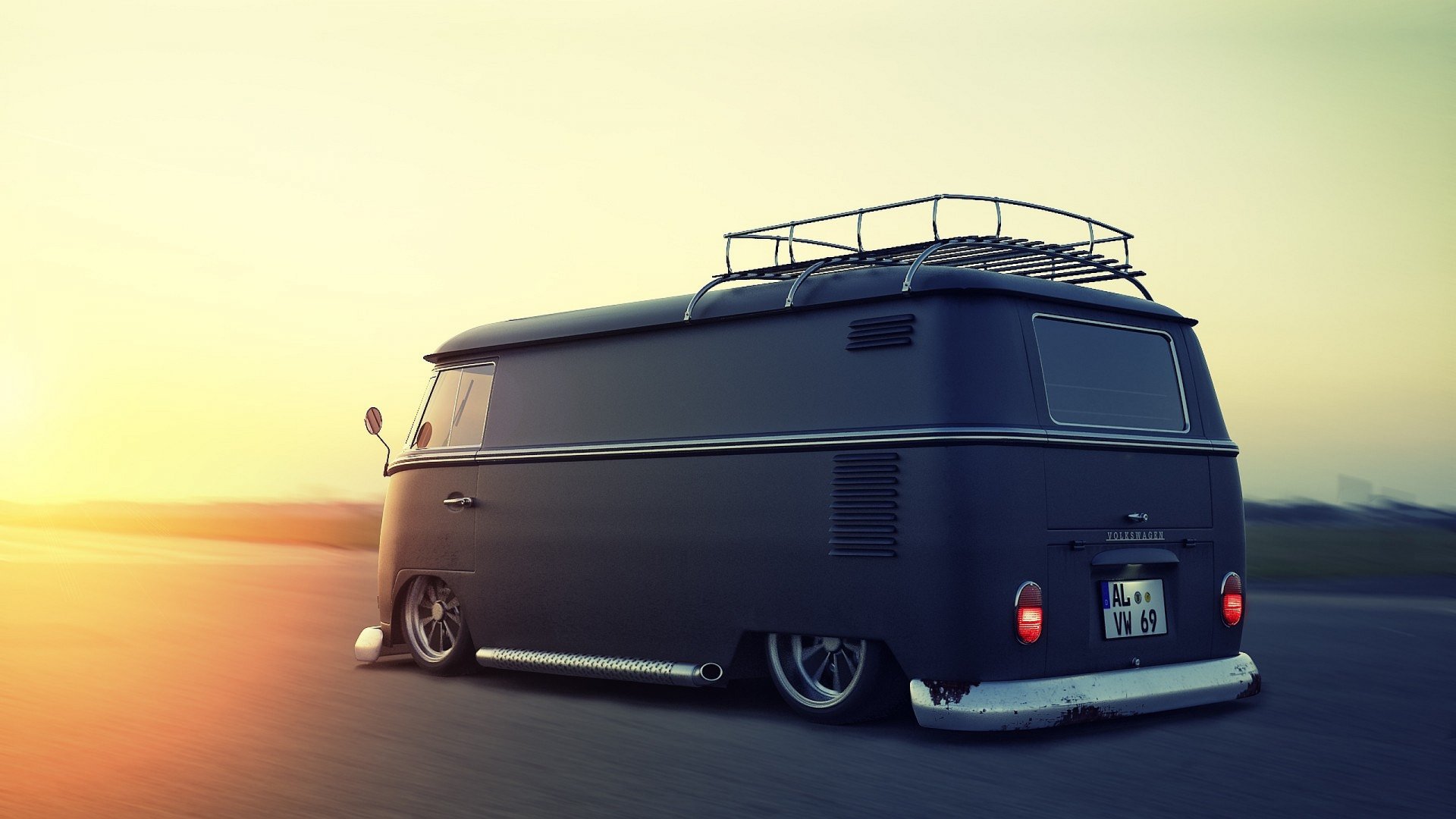 A vintage Volkswagen Microbus with a roof rack parked on an open road at sunset, showcasing its sleek design and unique style in this HD desktop wallpaper.