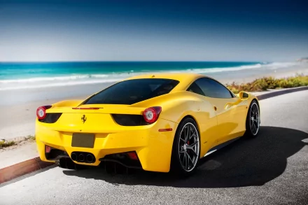 A sleek yellow Ferrari 458 Italia parked by the beach, showcasing its stunning design against the backdrop of turquoise waters and a clear sky.