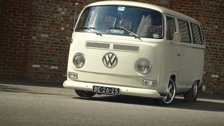 HD PC desktop wallpaper featuring a classic white Volkswagen Microbus parked against a brick wall, showcasing its vintage design and iconic round headlights.