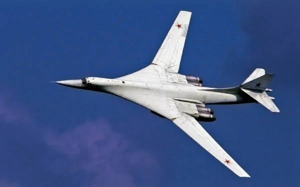 HD desktop wallpaper featuring a military Tupolev Tu-160 bomber jet soaring against a clear blue sky.