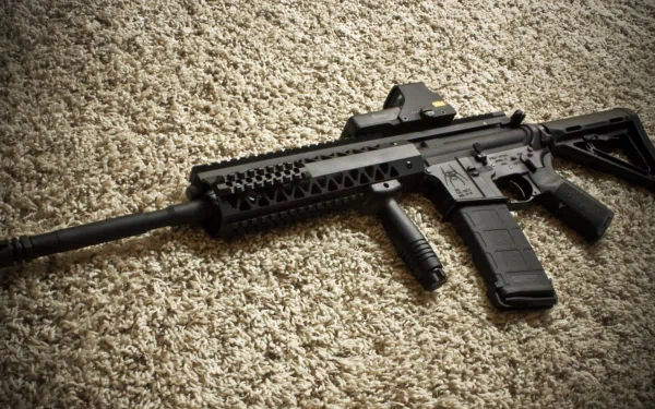 4K Ultra HD desktop wallpaper featuring a detailed man-made assault rifle resting on a textured carpet surface.