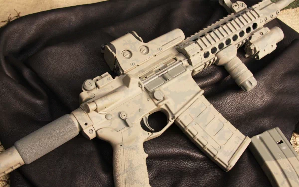 Close-up 4K Ultra HD image of a man-made assault rifle with attachments resting on a dark surface, showcasing intricate details and textures.