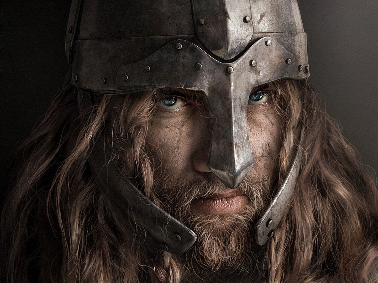 A close-up of a fierce fantasy warrior with long hair and a battle-worn helmet, embodying strength and courage. This HD wallpaper captures the essence of epic fantasy.