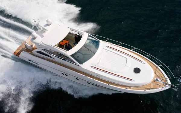 HD PC desktop wallpaper and background showing an aerial view of a white speed boat vehicle cutting through dark water, leaving a foamy wake.
