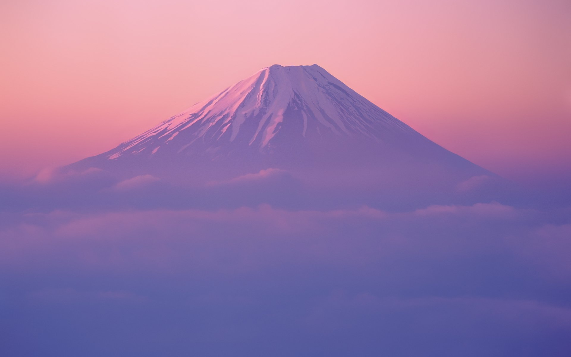 2K Quad HD PC desktop wallpaper and background: Mount Fuji rising above clouds at dawn, soft pink and purple sky — nature landscape.
