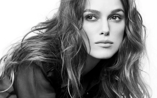 HD desktop wallpaper featuring a striking black and white portrait of Keira Knightley, showcasing her expressive features and flowing hair.