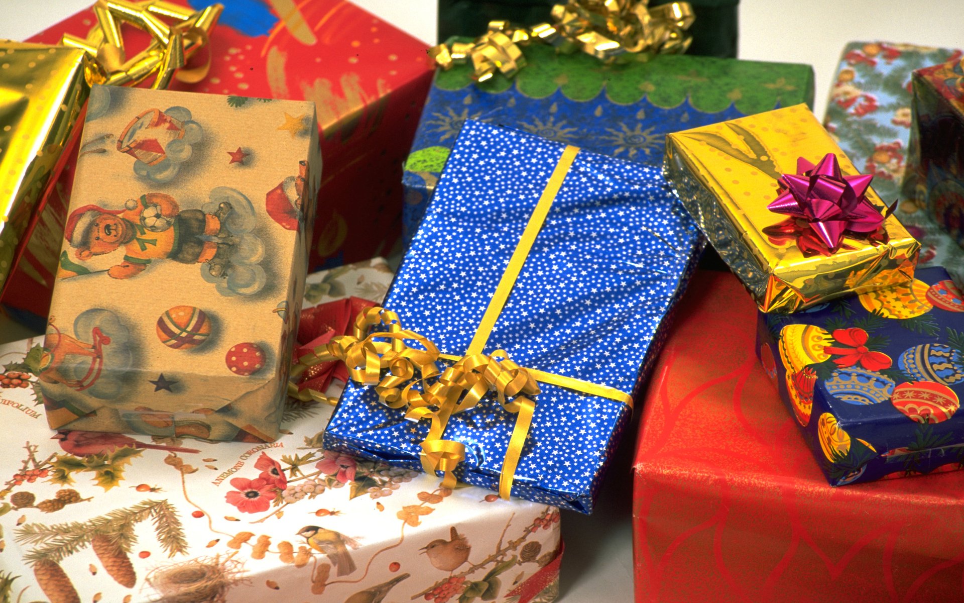 A colorful arrangement of beautifully wrapped gifts featuring vibrant patterns and bows, capturing the festive spirit of holiday cheer and Christmas celebrations.