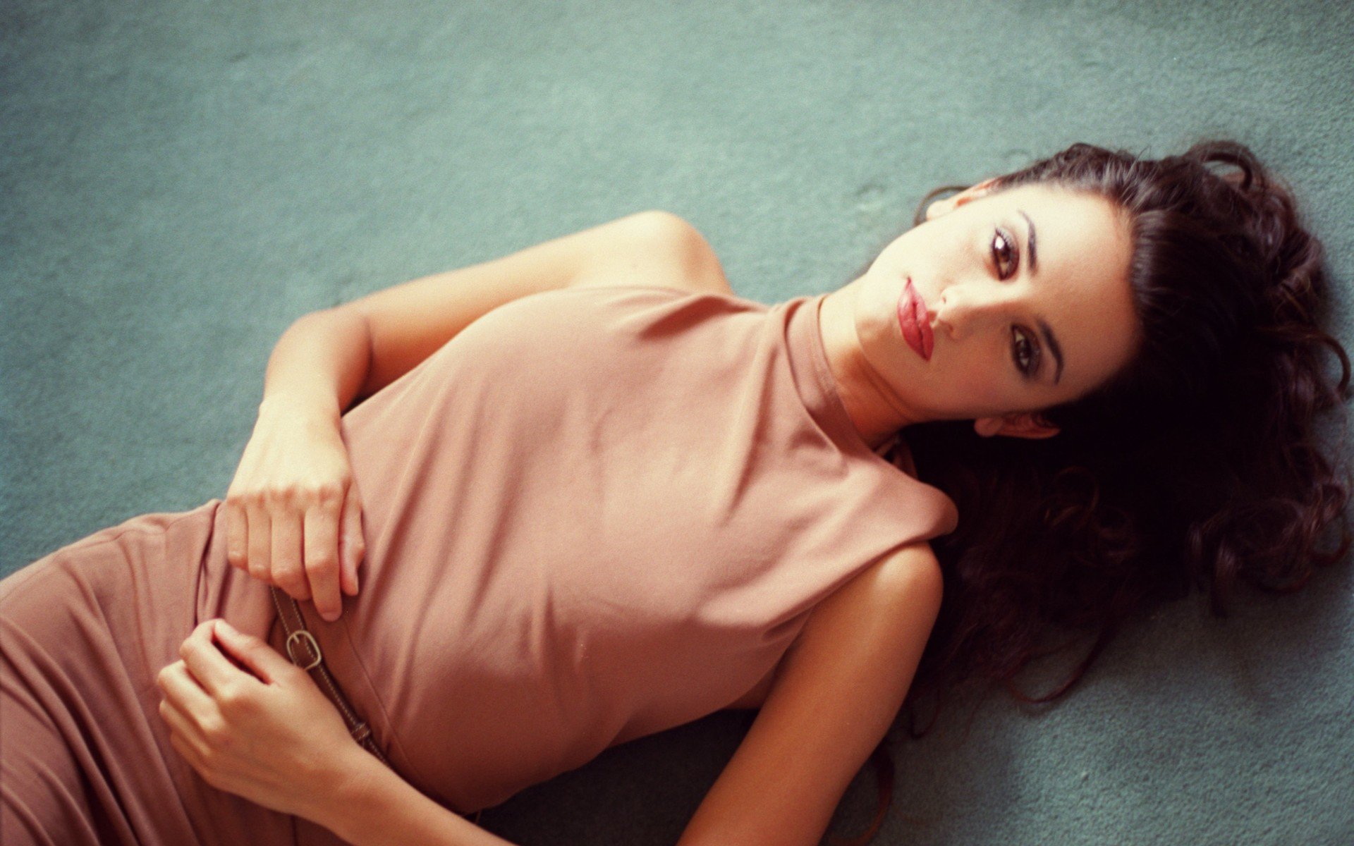 A stunning HD desktop wallpaper featuring celebrity Penelope Cruz, captured in a serene pose with long hair, exuding elegance against a soft background.