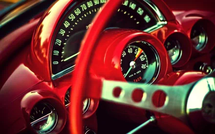 HD desktop wallpaper of a classic Chevrolet vehicle dashboard featuring a vibrant red steering wheel and detailed speedometer.