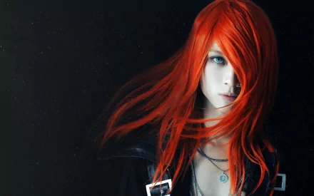 HD desktop wallpaper featuring a woman with striking red hair partially covering her face, set against a dark background. The image emphasizes dramatic lighting and intense expression.