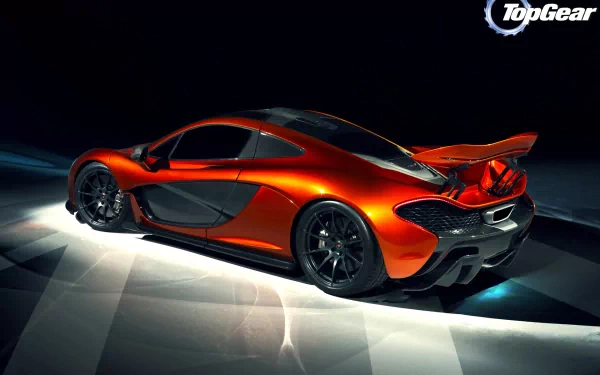 A striking McLaren P1 in vibrant orange, showcased against a sleek, dark background, serves as an impressive HD PC desktop wallpaper and background.