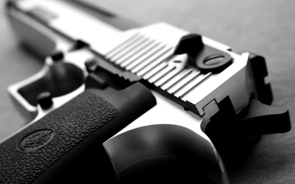 Close-up of a .50 cal Desert Eagle handgun, showcasing its sleek design in high definition, set against a monochrome background for an impactful desktop wallpaper.