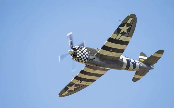 HD PC desktop wallpaper featuring a vintage military aircraft with black and yellow stripes flying against a clear blue sky.