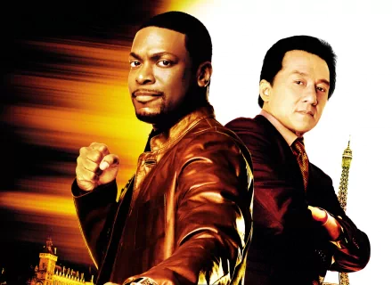 Chris Tucker and Jackie Chan pose back-to-back in this action-packed HD wallpaper from the movie Rush Hour, featuring vibrant colors and a dynamic backdrop.