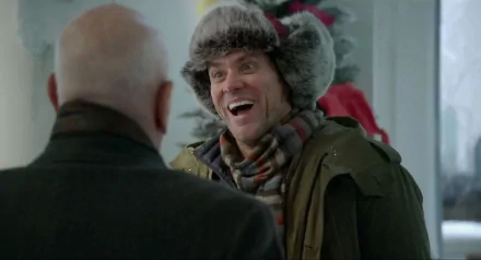 HD desktop wallpaper featuring Jim Carrey in a winter outfit from the movie Mr. Popper's Penguins, smiling and interacting with another character indoors.