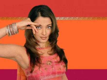 HD desktop wallpaper featuring celebrity Aishwarya Rai in a pink traditional outfit against a vibrant orange and red background.