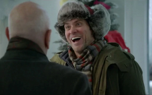 HD desktop wallpaper featuring Jim Carrey in a winter outfit from the movie Mr. Popper's Penguins, smiling and interacting with another character indoors.