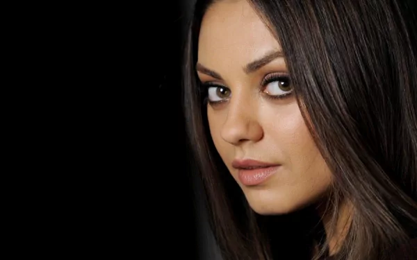 HD PC desktop wallpaper featuring a close-up portrait of celebrity Mila Kunis with a dark background.