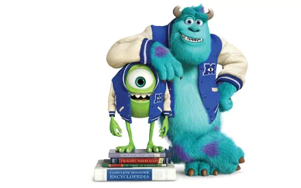 James P. Sullivan and Mike Wazowski stand together in Monsters University gear, posing playfully beside a stack of books. This vibrant HD wallpaper captures their iconic friendship.