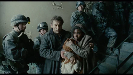 HD wallpaper featuring a tense scene from Children Of Men with Clive Owen protecting a woman amidst soldiers.