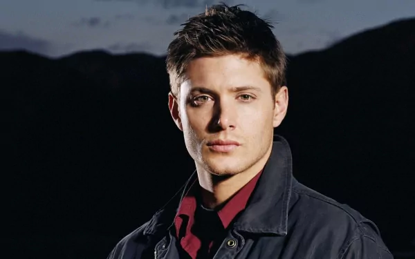 HD PC desktop wallpaper featuring celebrity Jensen Ackles against a dark mountainous background.