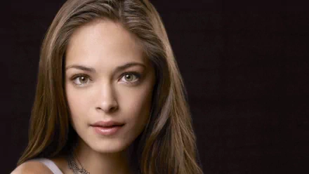 HD PC desktop wallpaper featuring a close-up portrait of celebrity Kristin Kreuk against a dark background.