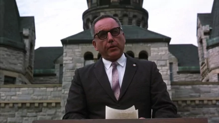 HD desktop wallpaper featuring a character from The Shawshank Redemption, portrayed by Bob Gunton, set against a stone building backdrop.