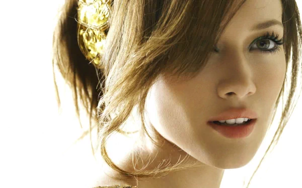 HD desktop wallpaper featuring celebrity Hilary Duff, showcasing her close-up with a soft expression and elegant hairstyle, highlighted by a delicate golden accessory.