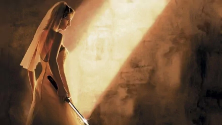 HD wallpaper of a bride from Kill Bill: Vol. 2 holding a sword, set against a dramatic light background.