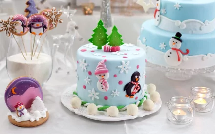A festive Christmas scene featuring a beautifully decorated blue cake adorned with snowflakes, a penguin, and a snowman, alongside holiday sweets and treats, creating a joyful atmosphere.