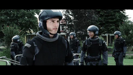 HD wallpaper featuring a scene from Minority Report with a focused man in tactical gear surrounded by a team.