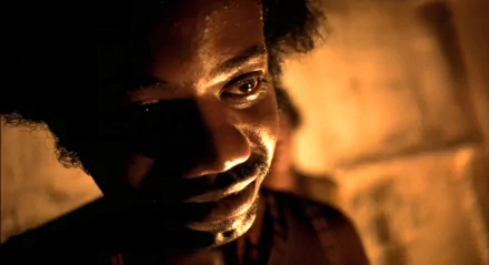 HD wallpaper featuring an intense close-up from the film City of God, with dramatic lighting highlighting a person's face.