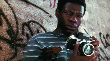 HD wallpaper of a scene from City of God with a person holding a camera, evoking the film's intense atmosphere.