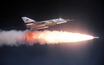 Convair F-106 Delta Dart military jet firing a rocket with a bright plume across a dark sky — 2K Quad HD PC desktop wallpaper background