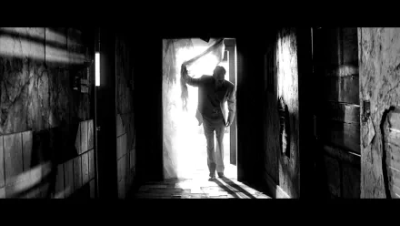 HD desktop wallpaper featuring a monochrome image of a person standing in a doorway, evoking themes from Memento.
