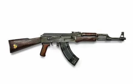 4K Ultra HD image of a man-made Kalashnikov AK 47 AKM assault rifle with wooden stock and metal body isolated on a white background.