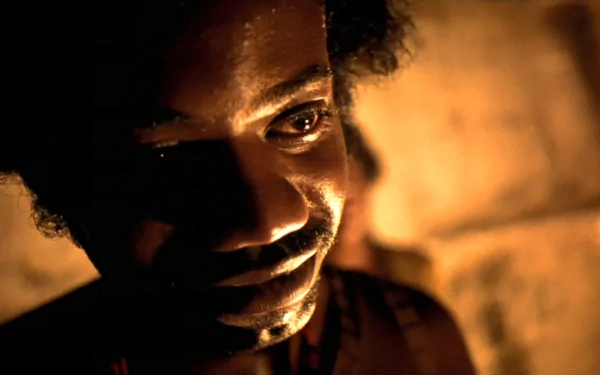 HD wallpaper featuring an intense close-up from the film City of God, with dramatic lighting highlighting a person's face.