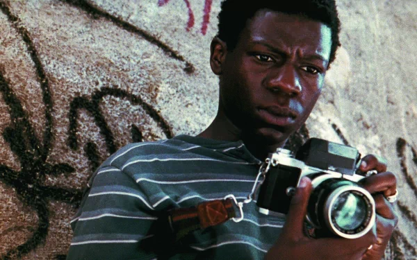 HD wallpaper of a scene from City of God with a person holding a camera, evoking the film's intense atmosphere.