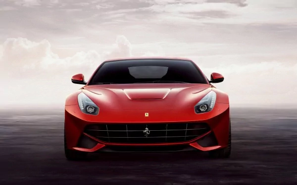 Red Ferrari F12berlinetta on a hazy background, showcased as an HD desktop wallpaper.