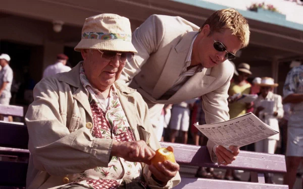 HD wallpaper featuring a scene from Ocean's Eleven with Brad Pitt and Carl Reiner at a racetrack.