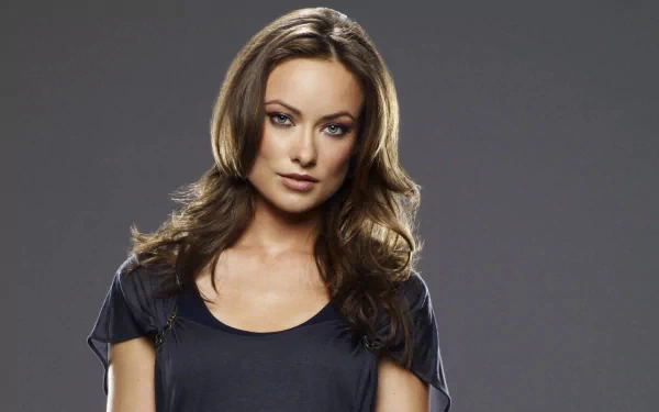 HD PC desktop wallpaper featuring a portrait of celebrity Olivia Wilde with a neutral gray background.