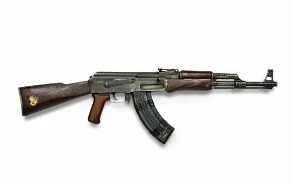 4K Ultra HD image of a man-made Kalashnikov AK 47 AKM assault rifle with wooden stock and metal body isolated on a white background.