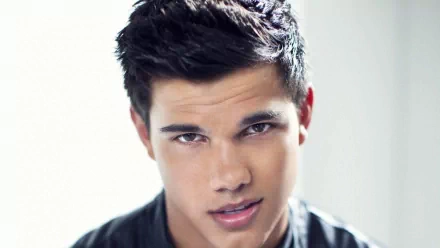 HD desktop wallpaper featuring Taylor Lautner, showcasing a close-up of his confident expression and stylish hairstyle against a softly blurred background.