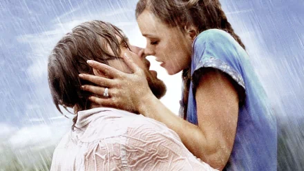 HD PC desktop wallpaper featuring an iconic romantic scene from the movie The Notebook, showing a couple embracing passionately in the rain.