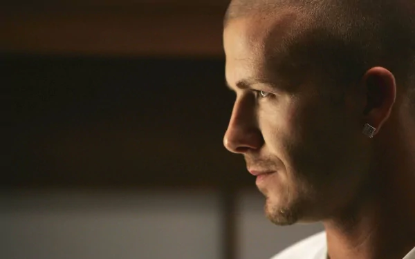 Close-up profile of David Beckham with soft lighting, captured in an HD sports-themed PC desktop wallpaper.