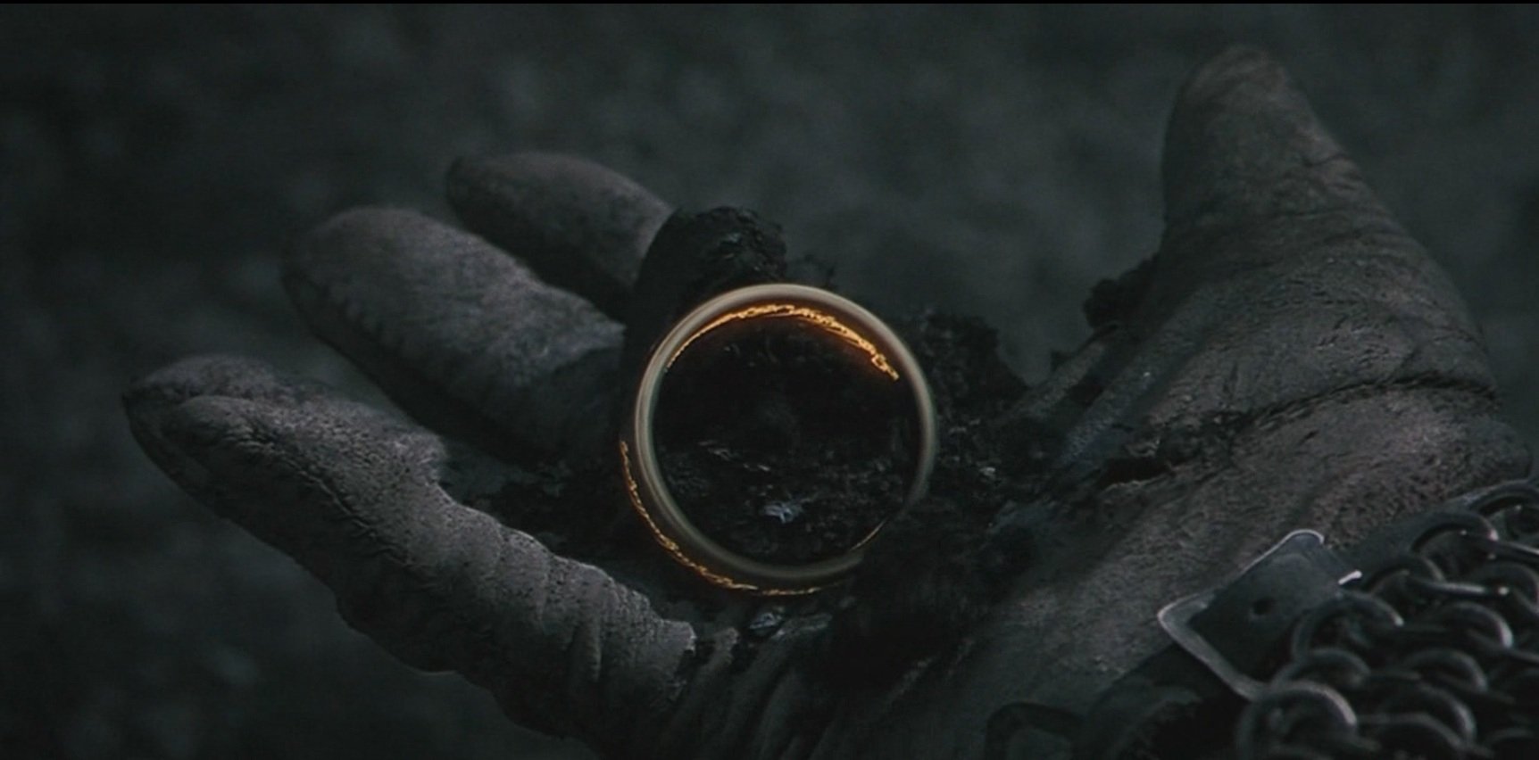 HD PC desktop wallpaper featuring a close-up of the One Ring held in a dark, gloved hand from the movie The Lord of the Rings: The Fellowship of the Ring.